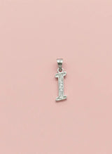 Silver letter 'I' pendant with small diamonds on a pink background