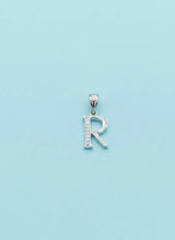 Silver 'R' pendant on a light blue background