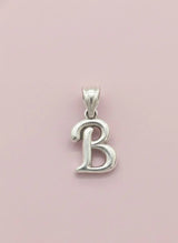 Silver 'B' pendant on a pink background