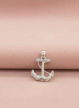Silver anchor pendant on a pink background