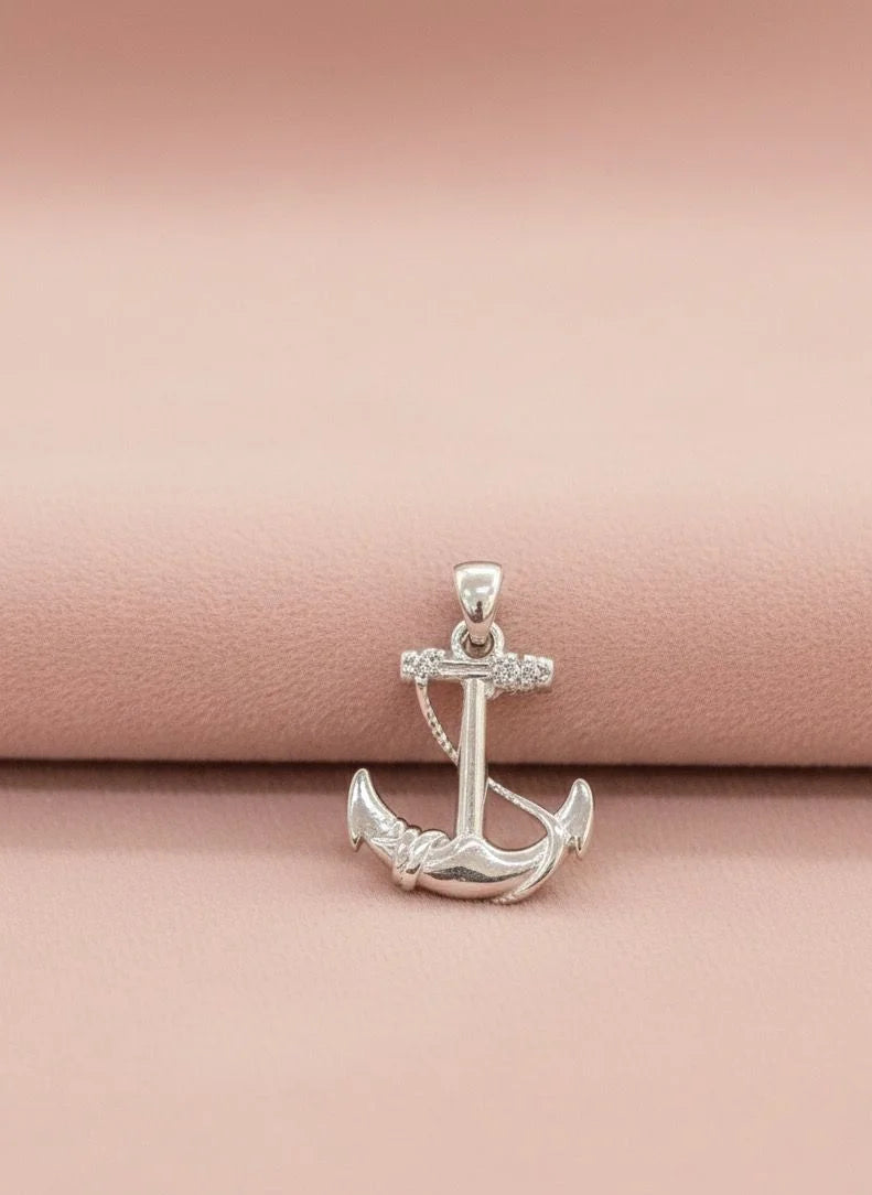 Silver anchor pendant on a pink background