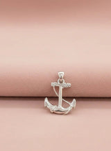 Silver anchor pendant on a pink background