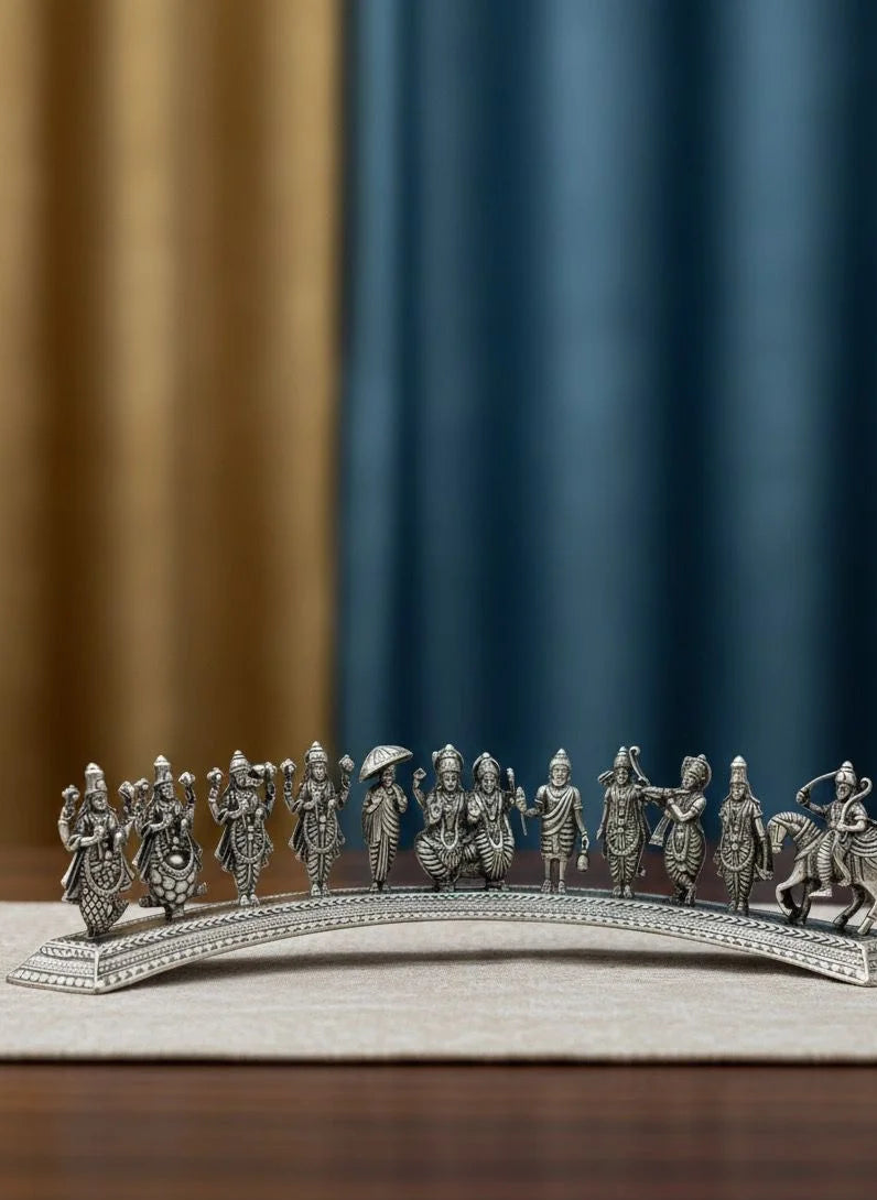Silver figurine of people on a bridge with a blue and brown curtain background
