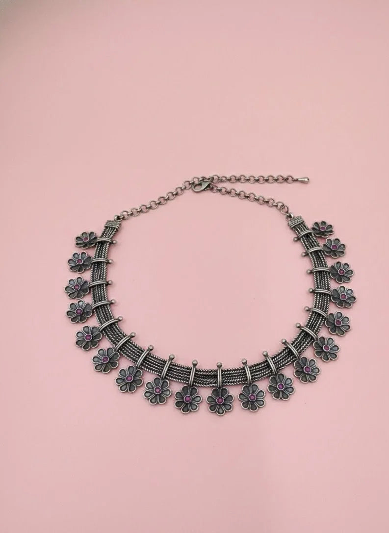 Decorative necklace on a pink background