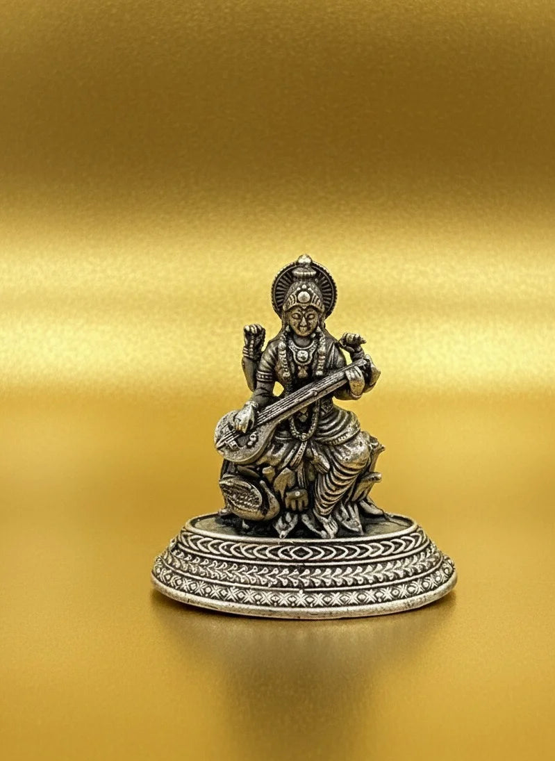 Statue of a seated figure holding a musical instrument on a gold background