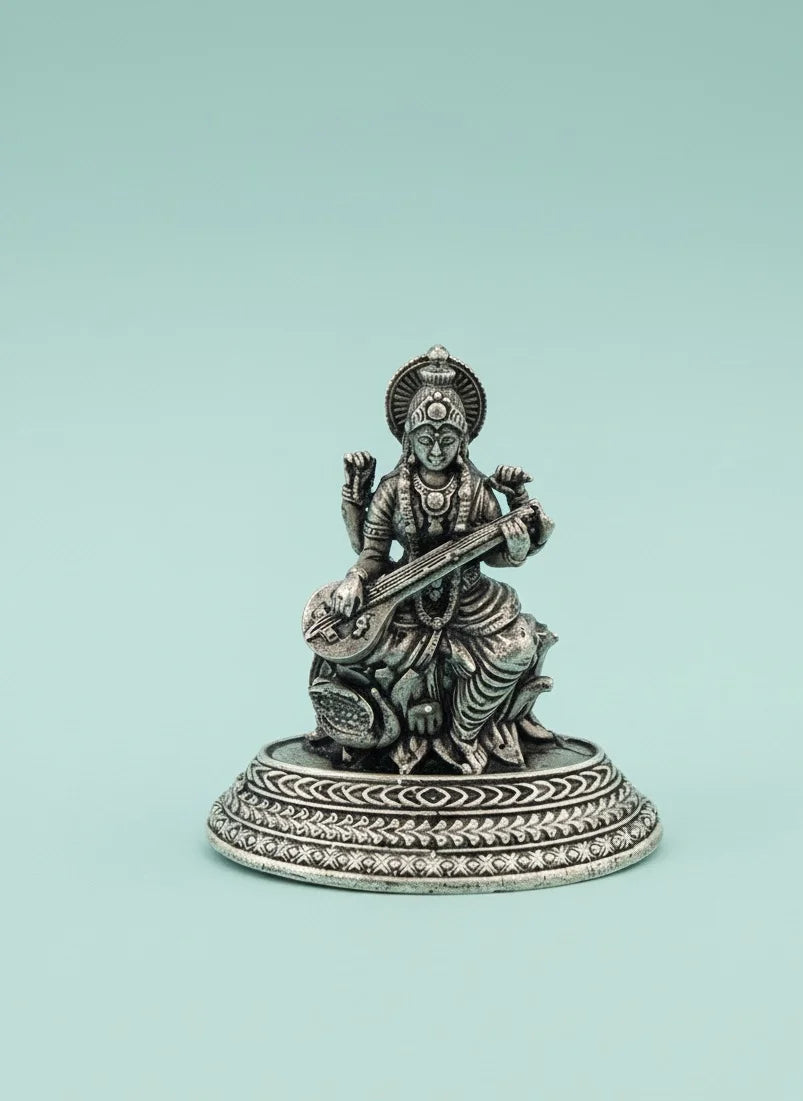 Silver statue of a musical instrument player on a light blue background