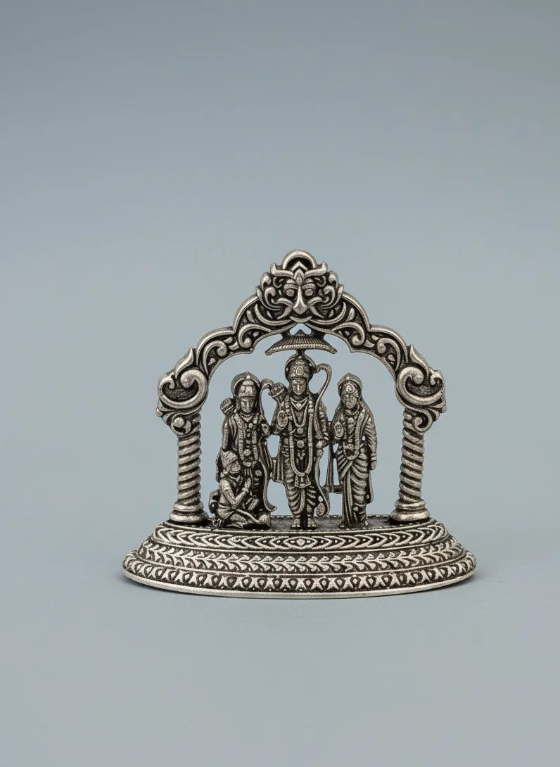 Decorative silver emblem with three figures on a gray background