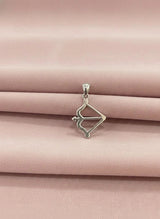 Silver pendant on a pink satin background