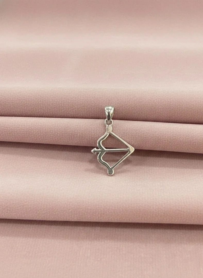 Silver pendant on a pink satin background