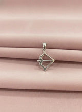 Silver pendant on a pink satin background