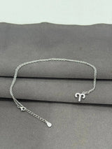 Silver necklace with a unique design on a gray surface