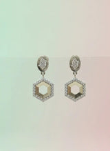 Hexagonal earrings on a gradient background