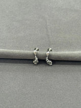 Pair of silver hoop earrings on a gray background