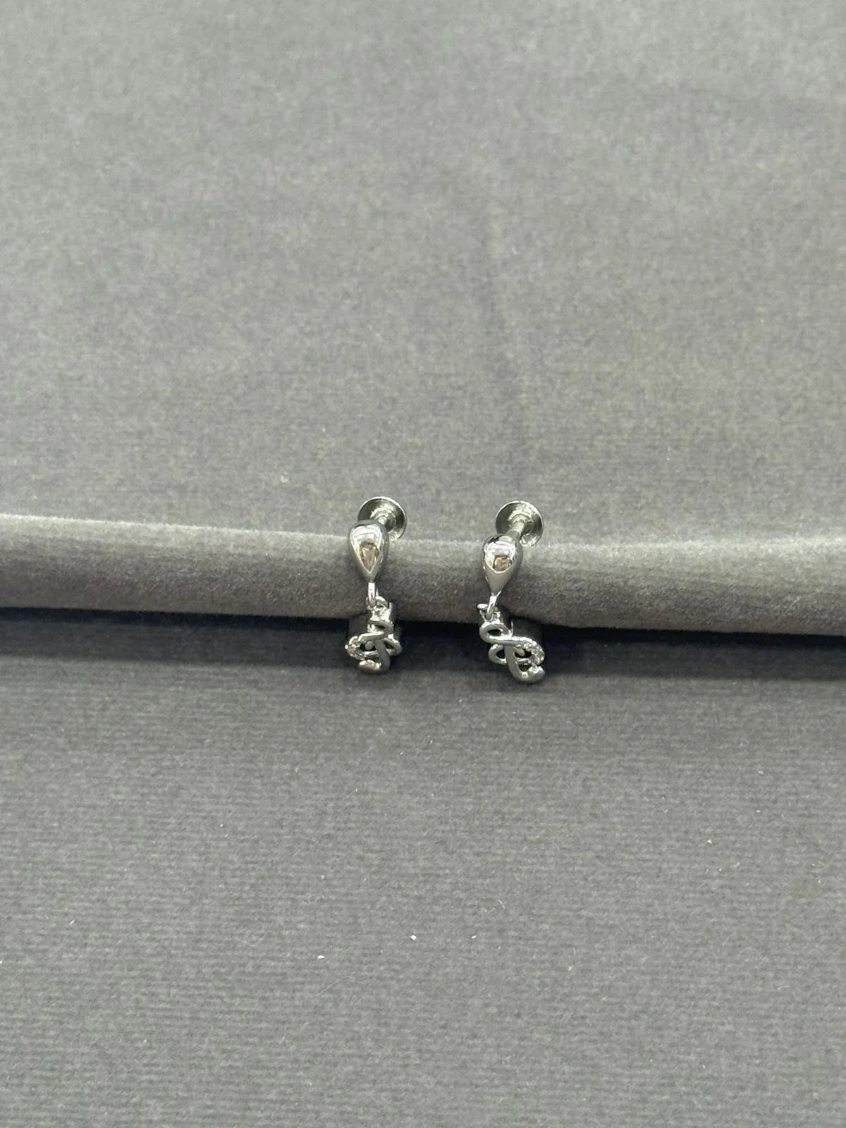Pair of silver hoop earrings on a gray background
