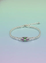 Silver bracelet with a butterfly charm on a gradient background