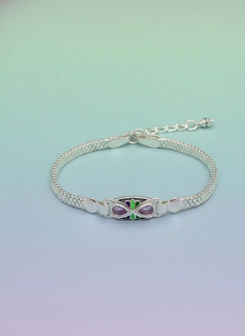 Silver bracelet with a butterfly charm on a gradient background