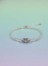 Silver bracelet with a butterfly charm on a gradient background