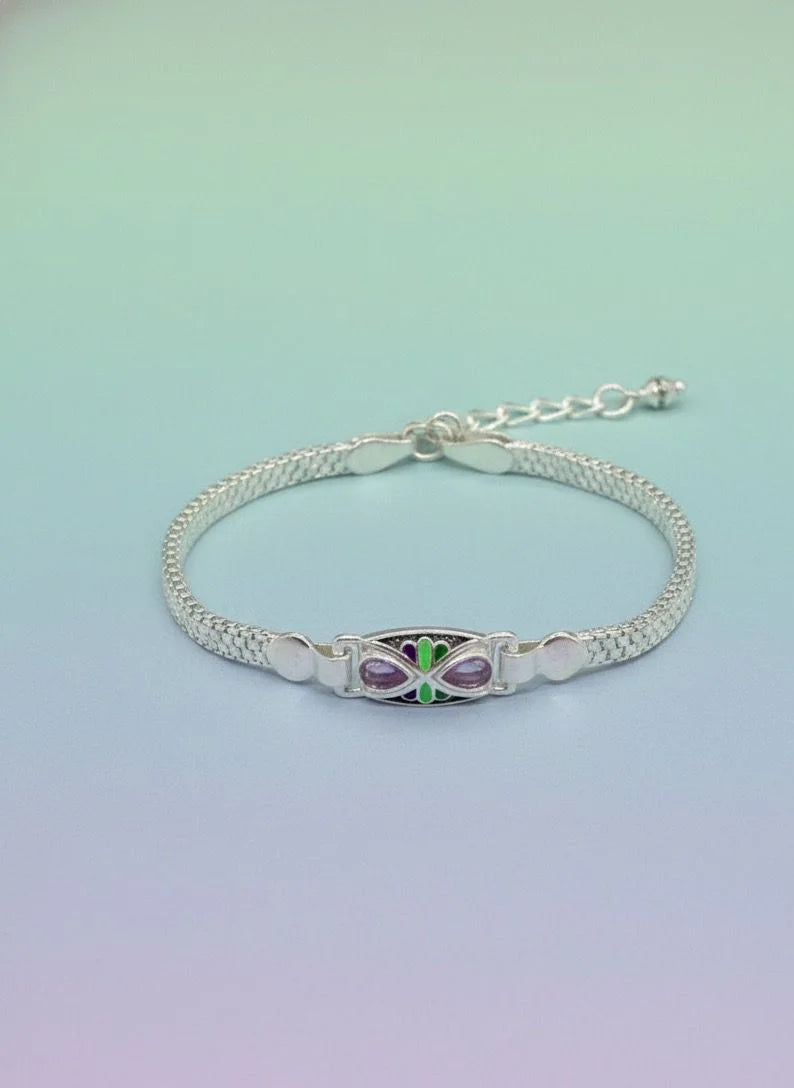 Silver bracelet with a butterfly charm on a gradient background