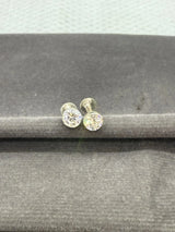 Pair of  stud earrings on a gray surface