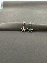 Starfish-shaped earrings on a gray surface