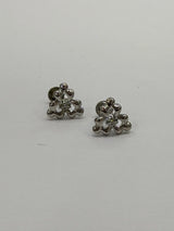Pair of silver floral earrings on a light gray background