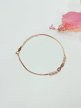 Gold bracelet with colorful beads on a light background