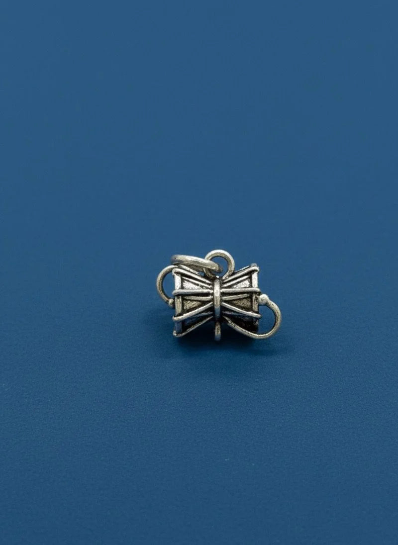 Silver bow-shaped charm on a blue background