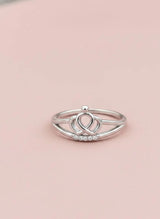 Silver ring with a unique design on a pink background