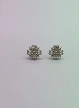 Pair of silver floral earrings on a light gray background