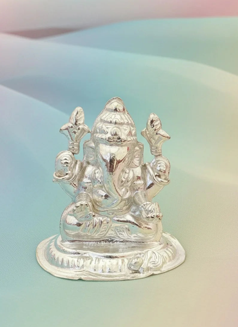 Silver statue of a deity on a gradient background