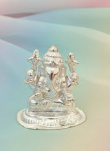 Silver statue of a deity on a gradient background