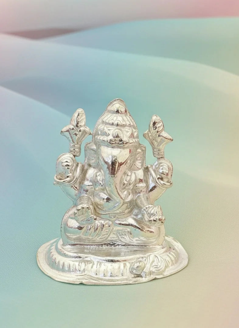 Silver statue of a deity on a gradient background