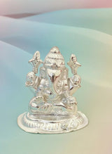 Silver statue of a deity on a gradient background