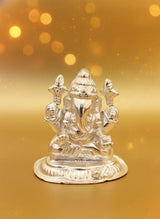 Silver statue of a deity on a gold background