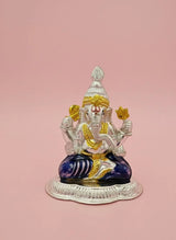 Decorative statue of a seated figure with colorful attire on a pink background