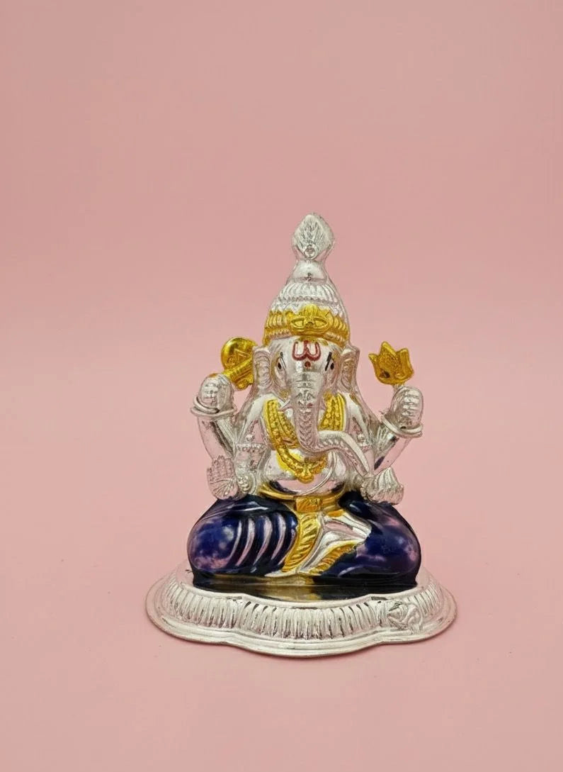 Decorative statue of a seated figure with colorful attire on a pink background