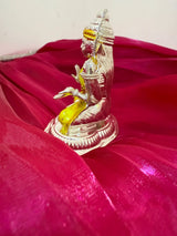 Silver and gold statue on a red fabric background