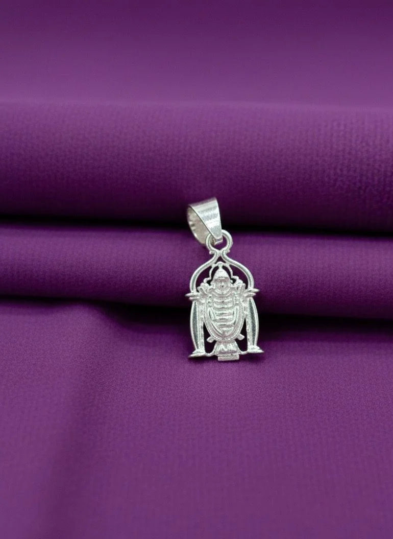 Silver pendant on a purple fabric background