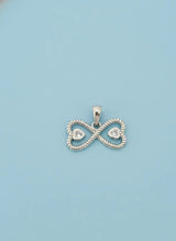 Silver infinity pendant with heart details on a light blue background