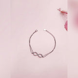 Silver bracelet with a unique design on a pink background