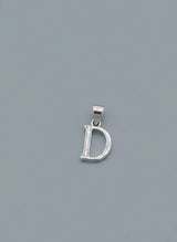 Silver 'D' pendant on a gray background