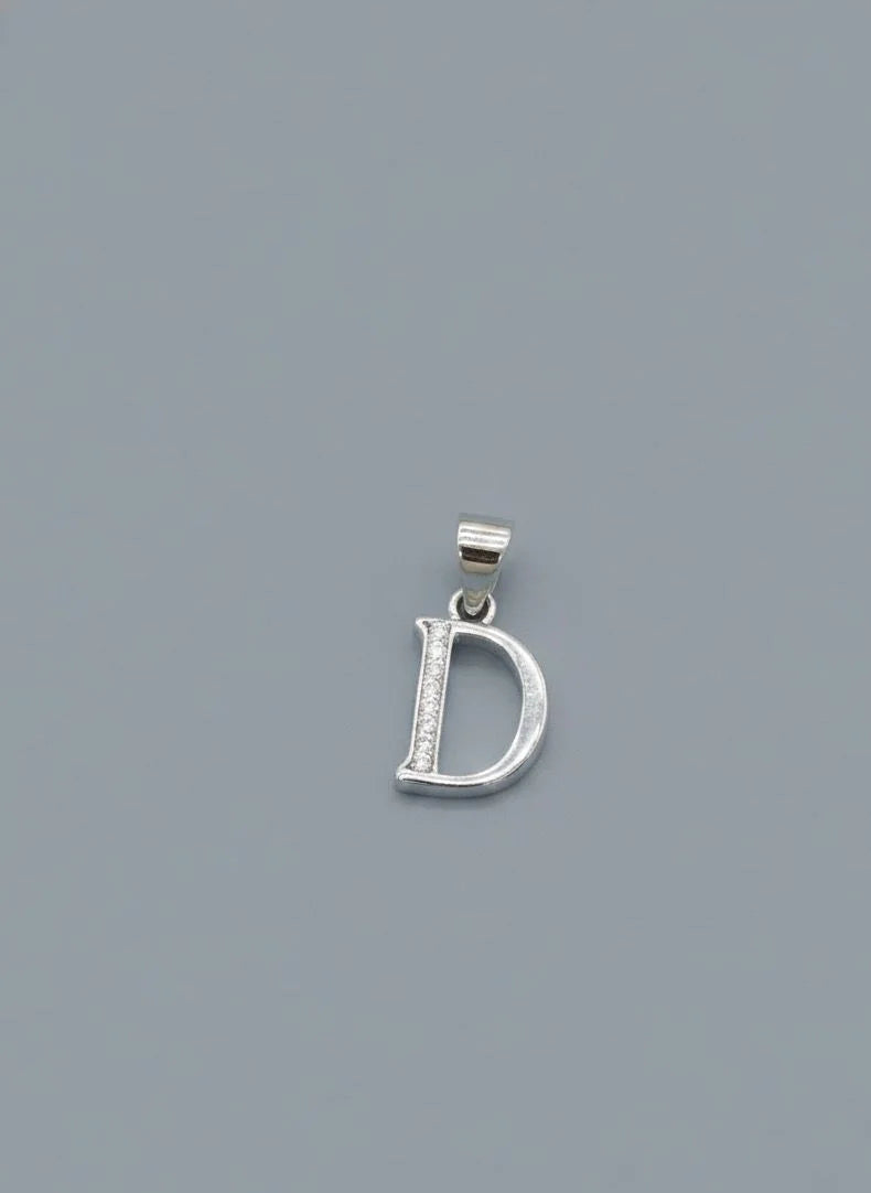 Silver 'D' pendant on a gray background