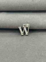 Silver letter 'W' charm with clear stones on a gray fabric background