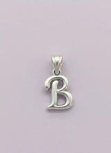 Silver 'B' pendant on a light purple background