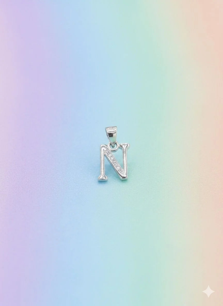 Silver necklace with a letter 'N' pendant on a pastel gradient background