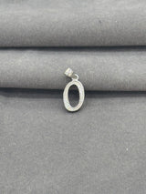 Silver pendant on a gray fabric background