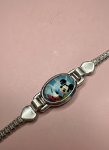 Bracelet with a character charm on a pink background