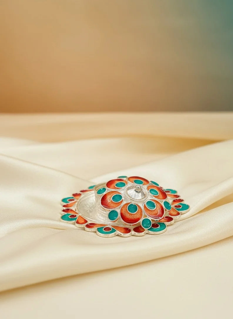 Decorative box with colorful design on a beige fabric background