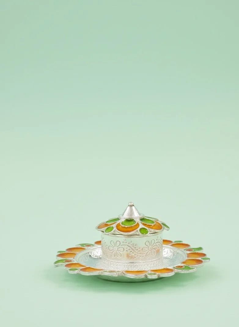 Decorative ceramic dish with lid on a light green background