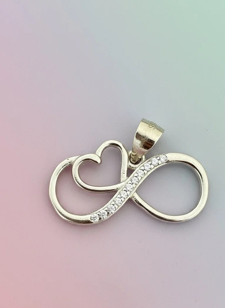 Silver pendant with heart and infinity symbol on a gradient background
